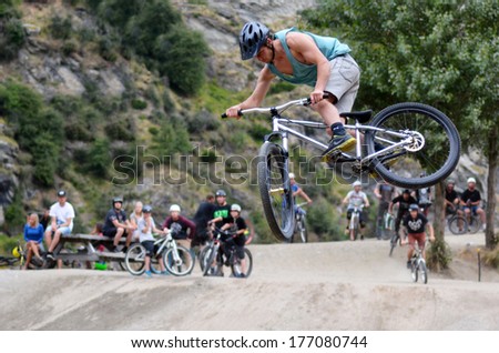Queenstown, Nz - Jan 15:Young Man Is Jumping With His Bmx Bike On Jan 15 2014 In Queenstown,Nz. The First Bmx Race Took Place In California In 1971.