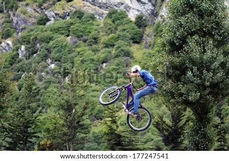 QUEENSTOWN, NZ - JAN 15:Young man performing tricks and stunts with his BMX Bike on Jan 15 2014.BMX riding became official Olympic sport in the 2008 Summer Olympic Games in Beijing, China.