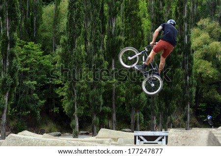QUEENSTOWN, NZ - JAN 15:Young manperforming tricks and stunts with his BMX Bike on Jan 15 2014 in Queenstown,NZ.  BMX stands for Bicycle Motocross and its known as a extreme sport.