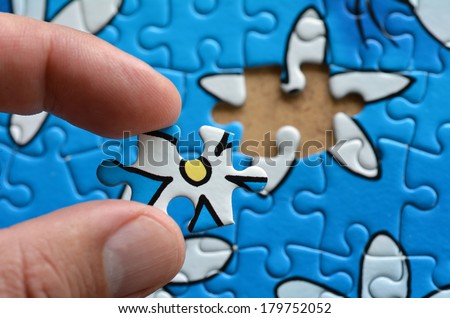 Person fitting the last puzzle piece.Business concept for completing the final puzzle piece