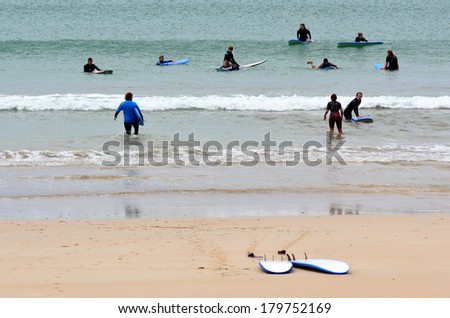 TAPOU BAY, NZ - FEB 14:Young surfers learn how to surf on Feb 14 2014.According to the International Surfing Association the estimate number of surfers worldwide is 23 million.