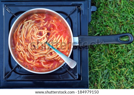 Caned spaghetti cooked on outdoor gas stove. Concept photo of food, preserved,outdoor, camping, survival,surviving,travel, vacation.