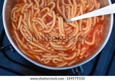 Caned spaghetti cooked on outdoor gas stove. Concept photo of food, preserved,outdoor, camping, survival,surviving,travel, vacation.