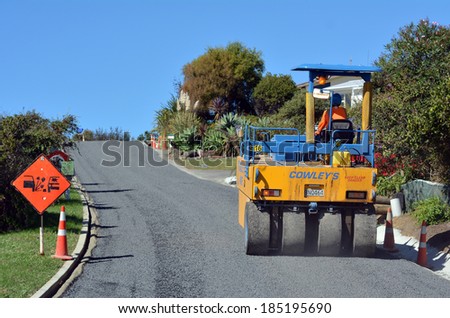 CABLE BAY, NZ - APR 01 2014:Road roller on asphalt pavement works (road repairing). There are more than four million miles of highways and roads in the U.S alone.