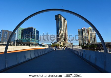 MELBOURNE,AUS - APR 14 2014:Pedestrians cross on Webb Bridge.It\'s an award winning bridge forming a cycling and pedestrian link to the main part of Docklands, through Docklands Park.