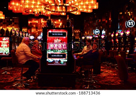 MELBOURNE, AUS - APR 11 2014:Visitors play on Gamble machines at Crown Casino, Melbourne.It\'s the largest casino complex in the Southern Hemisphere and one of the largest in the world.