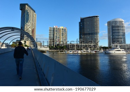 MELBOURNE - APR 14 2014:New towers and bridge rises above the Yarra river in Docklands Melbourne.The development of Melbourne Docklands is one of the largest urban renewal projects in Australia.