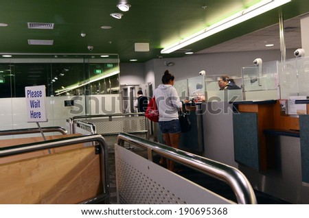 AUCKLAND - APR 10 2014:Passengers at New Zealand Customs and Border Protection checkpoint in Auckland airport.The agency responsible for the safety, security and commercial interests of New Zealand.