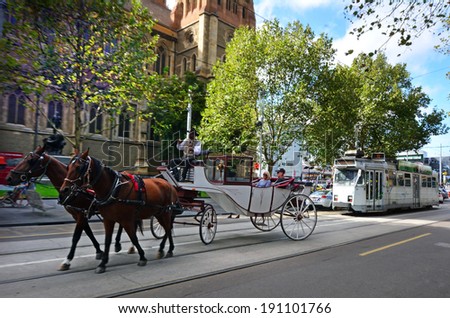 MELBOURNE,AUS - APR 13 2014:Horse carriage in front of Melbourne tramway.It\'s the largest urban tramway network in the world consisted of 250 km (155.3 mi) of track,487 trams,30 routes and 1,763 stops