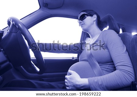 pregnant woman drive a car during pregnancy. Concept photo of pregnancy, pregnant woman lifestyle and health care.copyspace (BW)