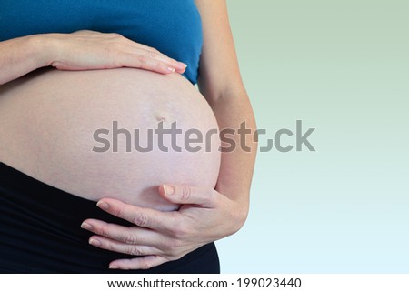 Pregnant woman touch her belly.Concept photo of pregnancy, pregnant woman, family, parenthood, motherhood. copyspace