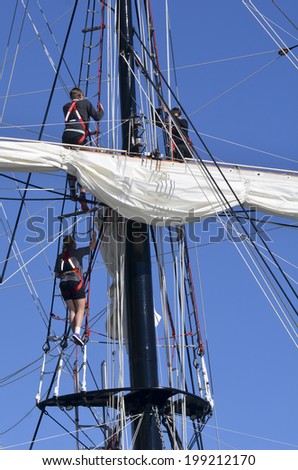 AUCKLAND - JUNE 01 2014:Sailors climb on to of the mast of Spirit of New Zealand. It\'s a tall ship with steel-hulled, three-masted barquentine that was built by the Spirit of Adventure Trust in 1986.