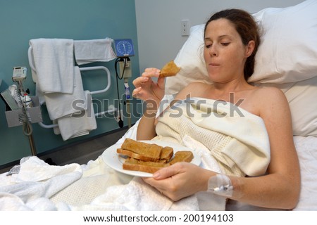 Hungry pregnant woman eats sweet food after childbirth.