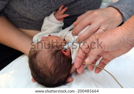 AUCKLAND - JUNE 09 2014:Newborn Infant (Naomi Ben-Ari age 0) during  hearing screening.Significant hearing loss is the most common disorder at birth. Approximately 1%-2% of newborns are affected.