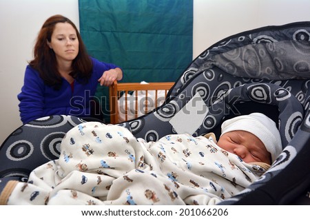 AUCKLAND - JUNE 09 2014:Depressed mother and her newborn (Naomi Ben-Ari age 0). Depression is a common during and after pregnancy. About 13 percent of pregnant women and new mothers have depression.