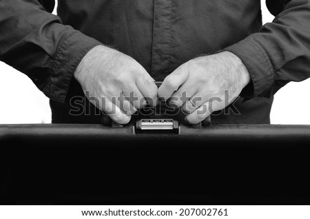 Hands of a man carry travel suitcase against white background with copy space. Concept photo of travel, vacation, holiday, destination, tourism, traveler, tourist. (BW)