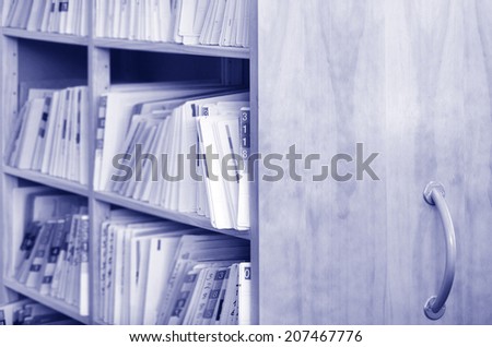 Medical record files on shelf of archive files cabinet. Concept photo for health care.  copy space.