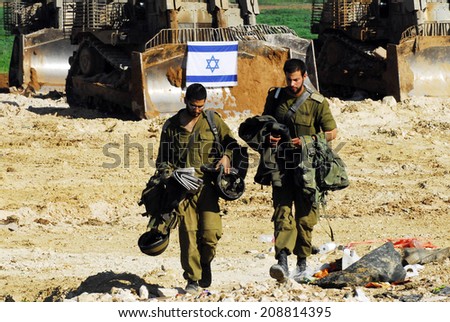 GAZA STRIP - JAN 18 2009:Israeli soldiers partially withdraw from Gaza into Israel, as both Hamas and Israel announce separate cease-fires.