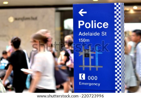 BRISBANE, AUS - SEP 25 2014:Australian people pass by Police Station sign.Gold Coast police on high terror alert warned to be hyper vigilant and patrol local mosques and critical infrastructure sites