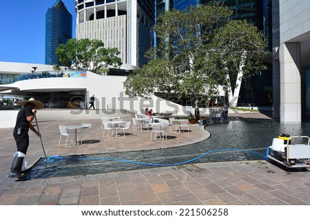 BRISBANE, AUS - SEP 25 2014:Swimming pool service technician clean a pool. there are about 15,000,000 residential pools and spas in the United States