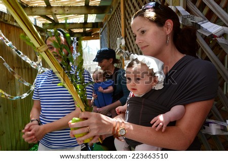 GOLD COAST - OCT 12 2014:Jewish people blessing on the four spices in a Sukkah on Sukkot Jewish Holiday.There are about 100,000 Jewish Australians they are 0.3 percent of the Australian population.