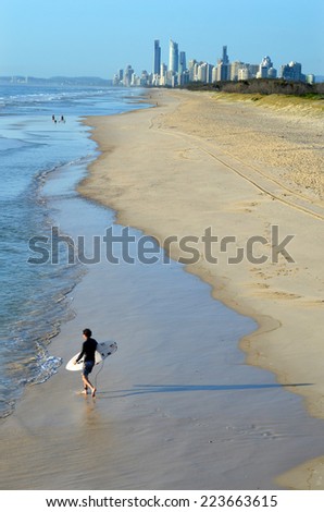 GOLD COAST - OCT 13 2014: Surfer get into the water of the Spit beach.It is a very popular surfing beach in Surfers Paradise Gold Coast Queensland, Australia.