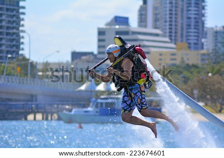 GOLD COAST - OCT 12 2014: Man ride a Jet pack.It can runs at 45 to 50 km/h (27 to 31 mph).
