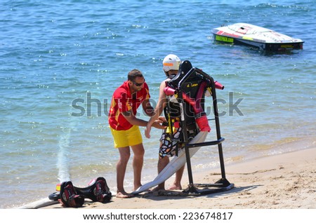 GOLD COAST - OCT 14 2014: Constructor prepare a man to ride on a Jet pack.In 2012, there was just one jet pack operation in the U.S. Now there are there are  more then 12.