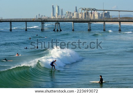 GOLD COAST - OCT 13 2014: Surfers in the Spit beach.It is a very popular surfing beach in Surfers Paradise Gold Coast Queensland, Australia.
