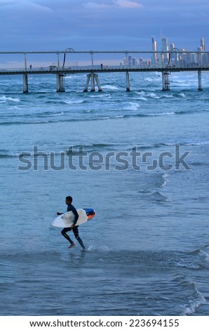 GOLD COAST - OCT 10 2014: Surfers get into the water of the Spit beach.It is a very popular surfing beach in Surfers Paradise Gold Coast Queensland, Australia.