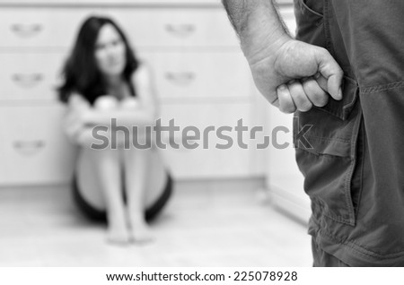 Woman in fear of domestic abuse. unrecognisable people. Concept photo of domestic violence , woman abuse and man violence.(BW) selective focus