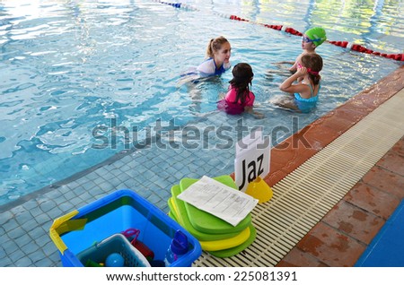 GOLD COAST - OCT 15 2014:Swimming trainer during swimming pool lesson.65% of people in the U.S. do not know how to swim.