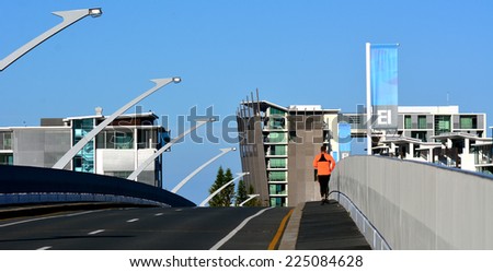 GOLD COAST - OCT 14 2014:Man runs over Ephraim Island bridge.It\'s a luxury residential development in Gold Coast, Australia.Some scenes for the feature film Jucy (2010) were shot on the island