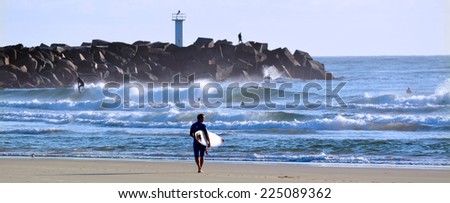 GOLD COAST - OCT 13 2014: Surfers in the Spit beach.It is a very popular surfing beach in Surfers Paradise Gold Coast Queensland, Australia.
