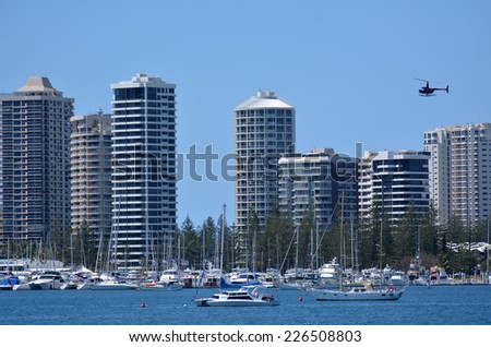 GOLD COAST - OCT 23 2014:Helicopter fly above Surfers Paradise Skyline.It one of Australia\'s iconic coastal tourist destinations, drawing about 10 million tourists every year from all over the world.