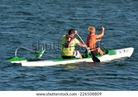 GOLD COAST- OCT 22 2014:Australian man and woman sea kayaking.It\'s a very popular sport in the waterway of the Gold Coast in Queensland, Australia.