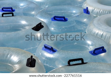 Inflatable clear inner tubes floating in clear blue waters