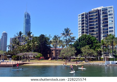 SURFERS PARADISE  - OCT 29 2014:People paddle board over Nerang River.With 9 times more waterways than Venice, Gold Coast is a boating paradise with over 260 Km of navigable waterways within the city.