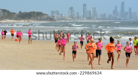 GOLD COAST, AUS - NOV 2 2014:Australian youth runs on the beach.Sport and physical activity for children reduce risk of obesity improve coordination and balance, better sleep and social skills.