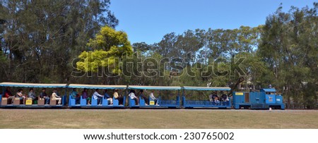 GOLD COAST, AUS -NOV 04 2014:Passengers rid on ridable miniature railway train in Currumbin Wildlife Sanctuary.The miniature railway has been operating since 1964.