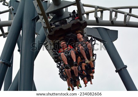 GOLD COAST, AUS -  NOV 06 2014:Visitors ride on Arkham Asylum Shock Therapy in Movie World Gold Coast Queensland Australia.It was the first steel inverted roller coaster at an Australian theme park