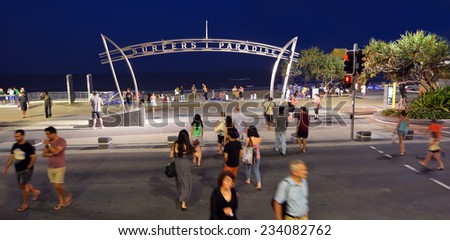 SURFERS PARADISE - NOV 15 2014:Visitors  under surfers paradise arch at night.It\'s Australia\'s iconic coastal tourist destinations drawing 10 million tourists a year from all over the world.