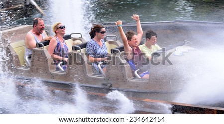 GOLD COAST, AUS -  NOV 12 2014:Visitors ride on Wild West Falls Adventure Ride in Movie World Gold Coast Queensland Australia.It\'s an 8-seater flume ride with the largest drop of its kind in Australia