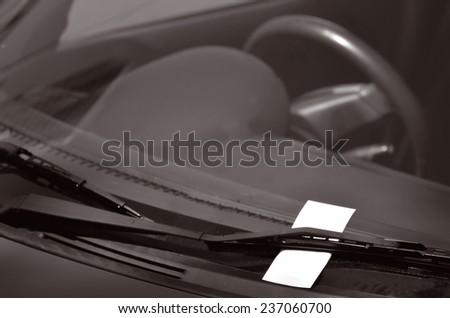 Parking ticket on car windscreen. transportation and vehicle concept