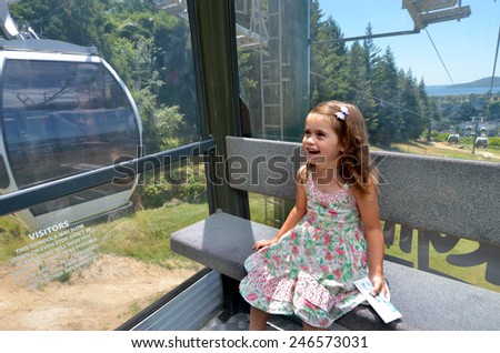 ROTORUA, NZL - JAN 18 2015:Girl (Talya Ben-Ari age 04) travel on Skyline Gondola Cableway.It\'s a 900 metre long  Cableway with a vertical rise of 178.5M on Mount Ngongotaha in Rotorua, New Zealand.