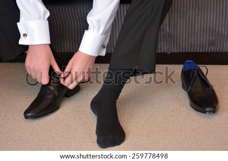 Man (bridegroom) wearing elegant men shoes on his wedding day.