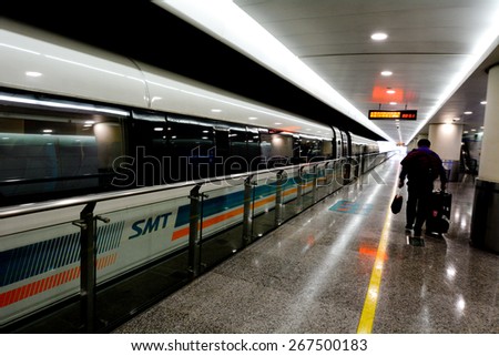 SHANGHAI, CN - MAR 18 2015:Passengers getting off Shanghai Maglev Train.The Shanghai Maglev has a length of 153m, a width of 3.7m, a height of 4.2m and a three- class, 574- passenger configuration.