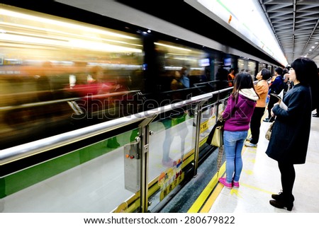 SHANGHAI, CH - MAR 25 2015:Passengers in Shanghai Metro train station. Shanghai Metro ranks third in the world in annual ridership, with 2.5 billion rides delivered in 2013.