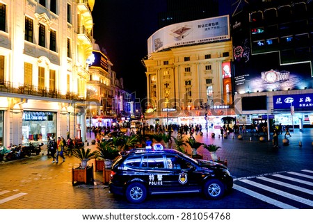 SHANGHAI - MAR 17 2015:Chinese police car guarding Nanjing Road in Shanghai, China.Since 2001, over 7,000 Chinese citizens convicted on terrorism charges mainly Tibetan and Muslim Uyghur ethnic groups