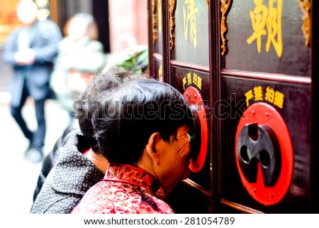 SHANGHAI, CN - MAR 15 2015:Chinese people watching Chinese Shadow Puppetry show in Shanghai, China.The art of Chinese Shadow Puppetry dated back over 2000 years ago.